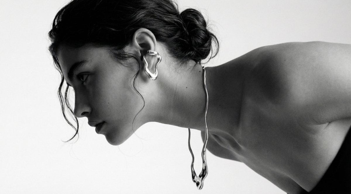 Minimal sculptural silver ear cuff and chain — Scandinavian design brand sourcing from India
