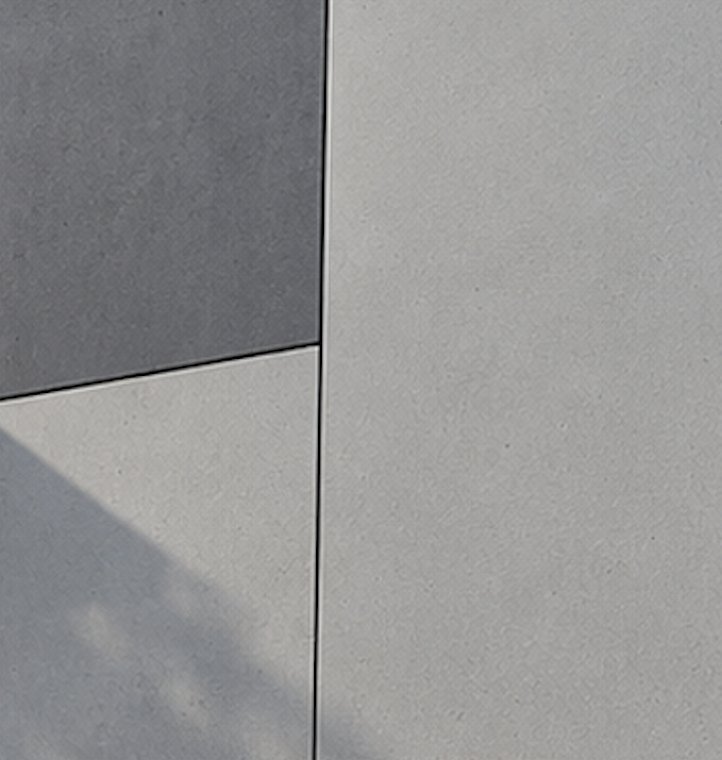 Joint between two fibre cement facade panels showing the open drained gap